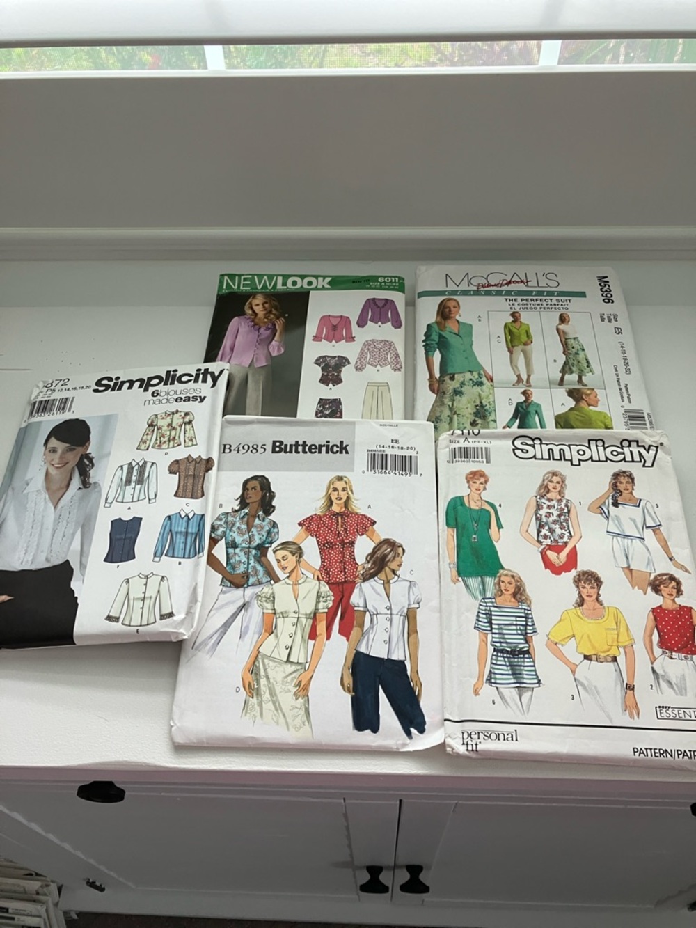Five uncut sewing patterns women’s blouses sizes 12–22